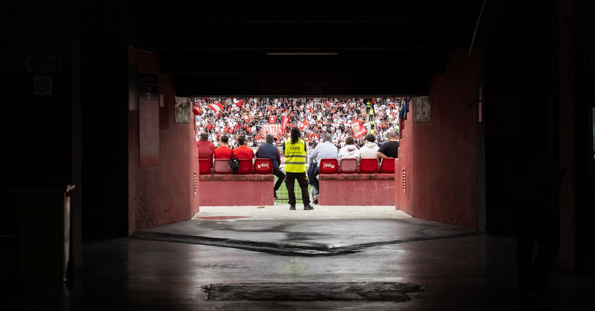 A dynamic stadium perspective through the tunnel showcasing engaged spectators during a game.