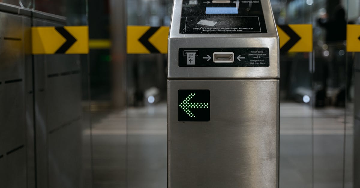 A modern ticket gate with an illuminated arrow for access control in transit systems.